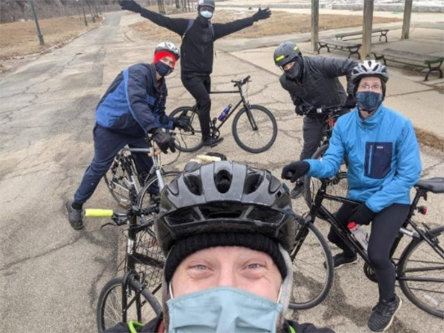 A selfie of five adult cyclists.