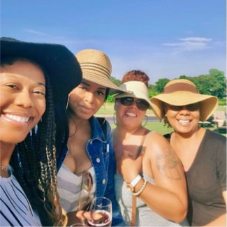 4 woman smiling outside on vacation