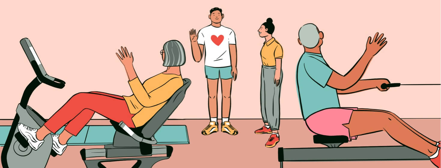 alt=a man waving at people on machines at a cardiac rehab center
