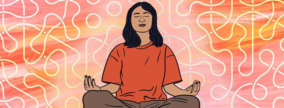 A woman sits with crossed legs and eyes closed while her hands rest on her knees to meditate